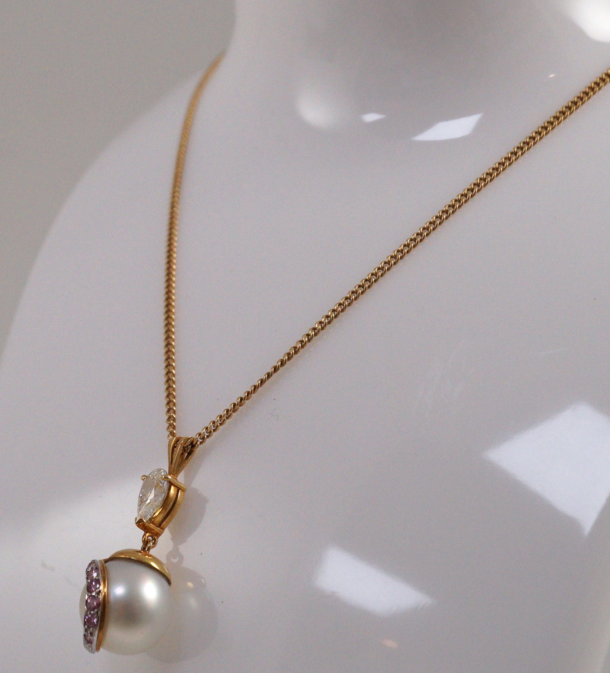 A modern gold, single stone South Sea pearl, single stone pear cut diamond and graduated seven stone pink diamond set drop pendant